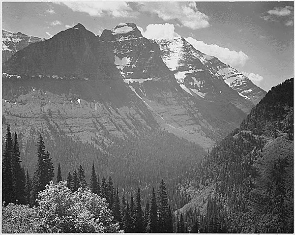 Ansel Adams: Valley, Snow Covered Mountains in background, "In Glacier National Park," Montana